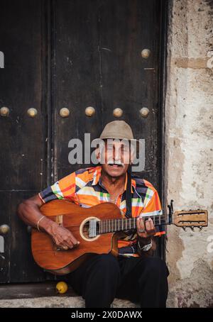 Old man playing a guitar on a street in Havana, Cuba Stock Photo