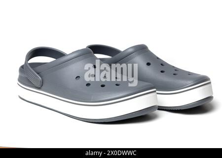 Gray crocs on a white background. Rubber shoes. Stock Photo