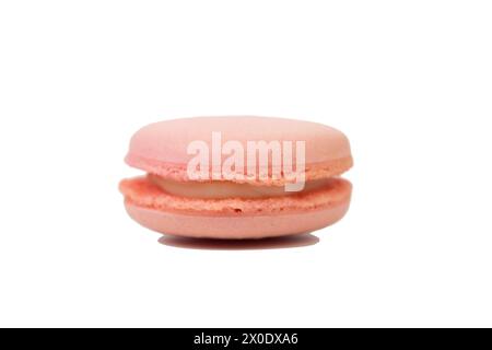 Pink delicious macaroons cookies with cream. It is isolated on white background. Close-up. Stock Photo