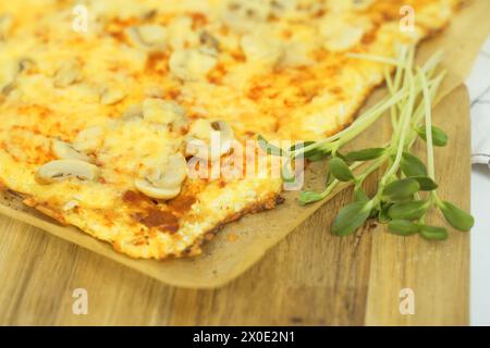 Close-up view of a plate with delicious vegetarian pizza and greens. The dish looks delicious and freshly prepared. Stock Photo