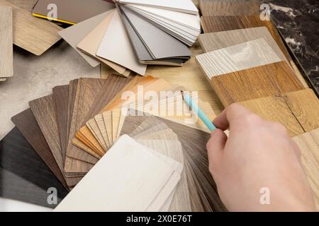 A woman designer shows with a pencil that she is holding in her hand, what is the best choice for the design of your project. The concept of design Stock Photo