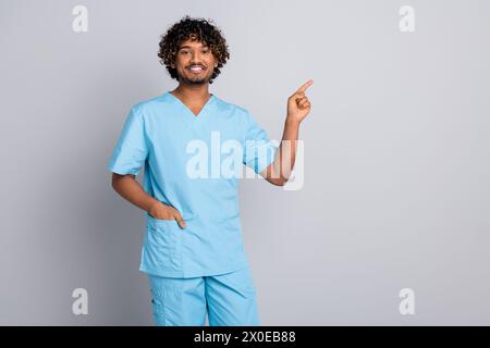 Photo of doctor guy point finger empty space advertising isolated grey color background Stock Photo