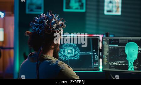 Engineer with EEG headset on programming brain transfer into computer ...