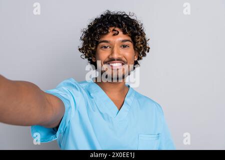 Photo of doctor guy make selfie smiling isolated grey color background Stock Photo
