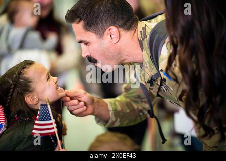 Cheyenne, Wyoming, USA. 4th Mar, 2024. U.S. Air Force Major Christopher Valine, a pilot with the 153rd Airlift Wing, Wyoming Air National Guard, inspects his daughter's missing teeth after a three-month deployment to U.S. Africa Command on March 5, 2024, in Cheyenne, Wyo. The primary mission of the C-130 Hercules aircraft is tactical airlift, transporting troops and cargo, which is what the airmen were responsible for during their deployment. (photo by Jon Alderman) (Credit Image: © U.S. National Guard/ZUMA Press Wire) EDITORIAL USAGE ONLY! Not for Commercial USAGE! Stock Photo