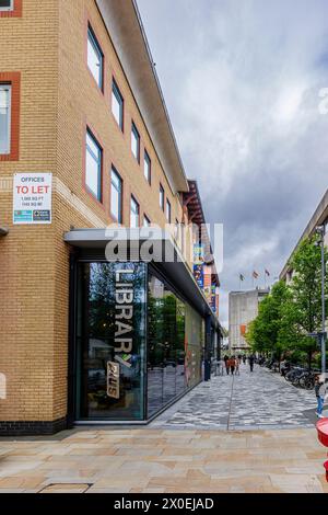 The modern glass-fronted public library in the town centre of Woking, a town in Surrey, England Stock Photo