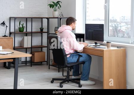 Focused male programmer working in office Stock Photo