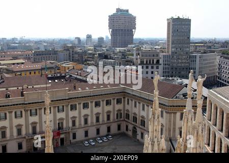 Torre Velasca and Piazza Diaz skyscraper, sculptured tops of of the Cathedral's spires in foreground, view from roof of the Cathedral, Milan, Italy Stock Photo