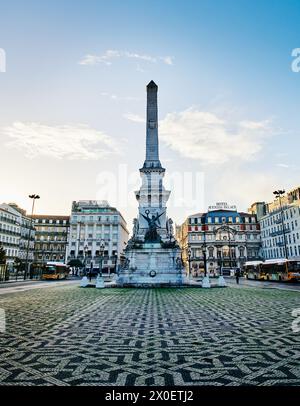 view of the Restauradores Square with Monumento aos Restauradores (Monument to the Restorers) obelisk in the middle during a fall day in Lisbon, Portu Stock Photo
