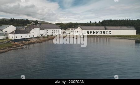 2018.08.07 - Laphroaig whiskey distillery, Port town Ellen, Islay Island, United Kingdom, Europe. Alcohol production industry. Factory at seascape. Industrial building, warehouse at sea bay shore Stock Photo