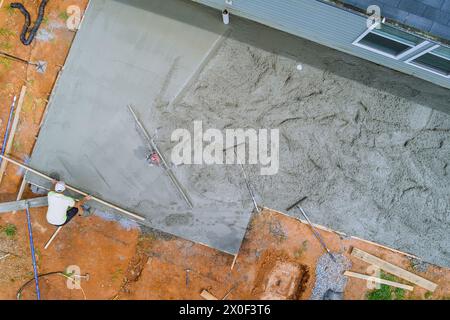 Construction worker leveling of concrete by using special tools Stock Photo