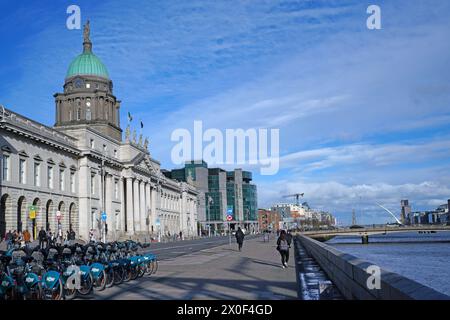 Dublin, Ireland, sidewalk beside River Liffey in front of the Custom House Stock Photo