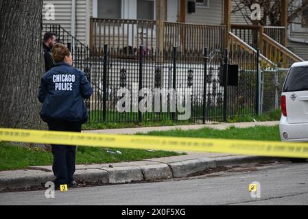 Chicago police officer takes photos of shell casings on the ground, a ...