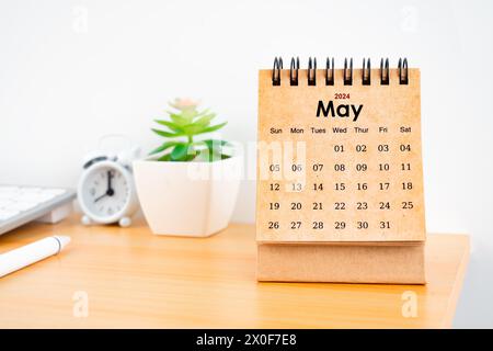 Front view of May 2024 desk calendar on worktable. Stock Photo