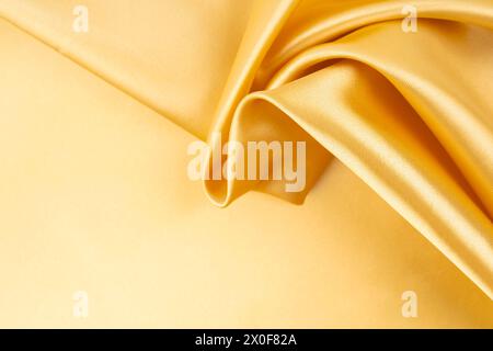 Golden Colored Fabric Textile, Abstract background. Stock Photo