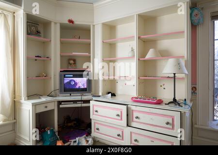 A kid's room with a with a television inside an abandoned house. Stock Photo