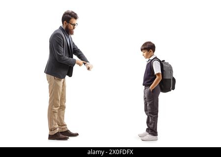 Full length profile shot of a man reprimanding a schoolboy and showing time on watch isolated on white background Stock Photo