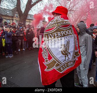 Liverpool FC supporters wearing flag before the kick-of at Anfield Stock Photo