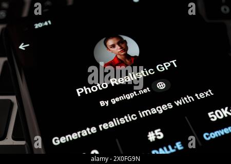 PHOTO REALISTIC GPT seen in GPT Store on the screen of smartphone placed on laptop keyboad. Stafford, United Kingdom, April 8, 2024 Stock Photo