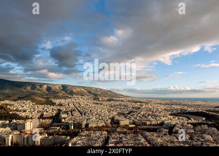 Majestic sunset with marvellous clouds over Hymettus mount and Athens city, Greece. There are several districts included like Ilioupoli, Pagkrati, Ili Stock Photo