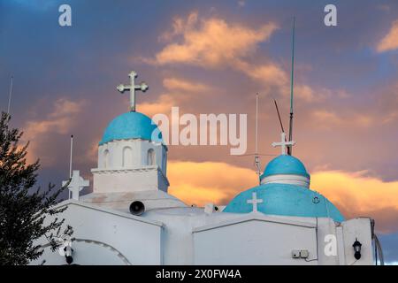 The chapel of Saint George (Agios Georgios) atop Lycabettus Hill in Athens, Greece during a glorious sunset with golden clouds. Stock Photo