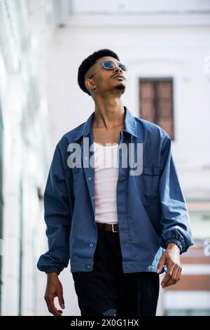 Successful confident trendy handsome young man walking in the city Stock Photo