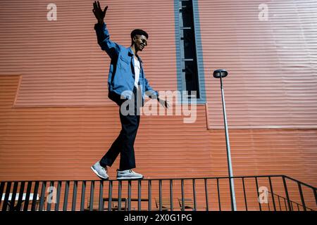 Focused trendy man balancing on a handrail. Stock Photo