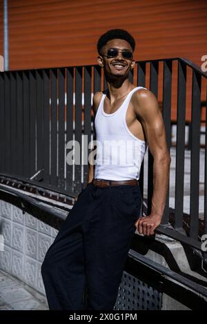 Satisfied successful male leaning against a handrail. Stock Photo