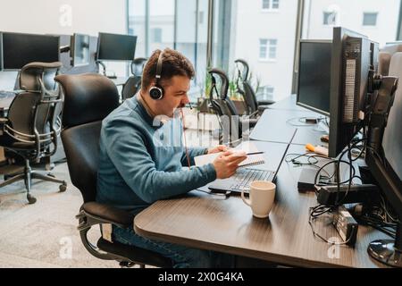 Young man working on laptop in office Stock Photo