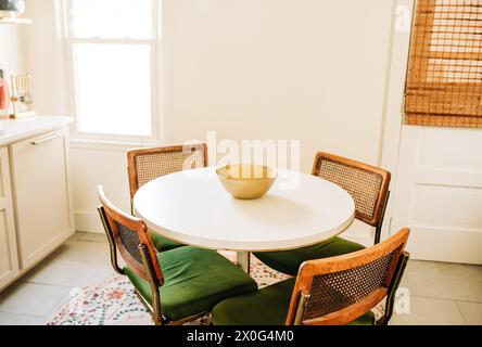 White Table With Four Chairs in a Boho Dining Room Stock Photo