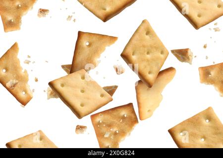 Tasty dry crackers falling on white background Stock Photo