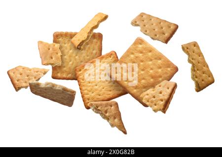 Tasty dry crackers falling on white background Stock Photo