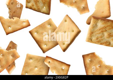 Tasty dry crackers falling on white background Stock Photo