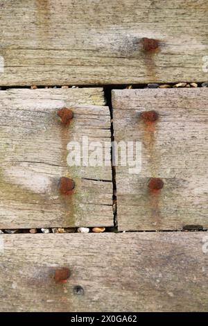 Close up of wooden groyne or breakwater on beach showing rusty rusting bolts rust concept security defence defences sea defence Stock Photo