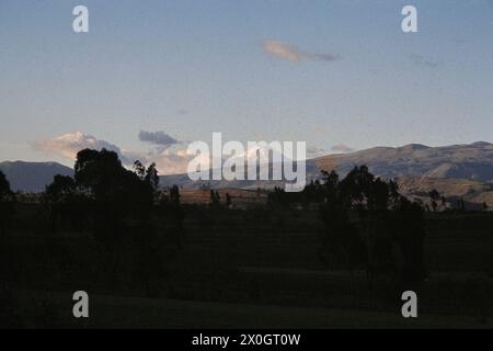 View from Ambatp to the snow covered and cloudy Cotopaxi volcano in Ecuador. [automated translation] Stock Photo