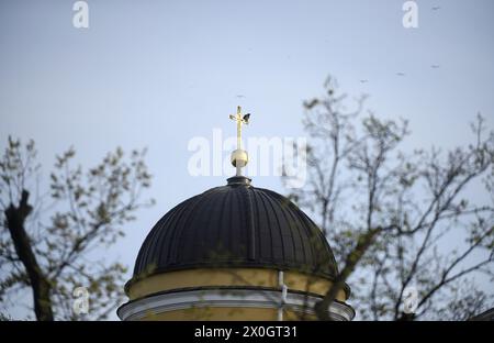 KYIV, UKRAINE - APRIL 11, 2024 - A cross crowns a dome, Kyiv, capital of Ukraine. Stock Photo
