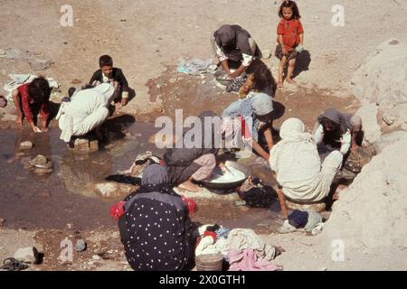 Women wash their clothes in a stream in Soltaniye. Stock Photo