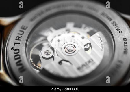 Lengnau, Switzerland - November 11, 2021: Watch movement is behind transparent back case of Swiss made self-winding mechanic wrist watch Rado Automati Stock Photo