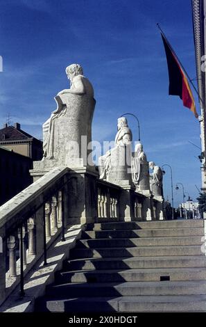 Rear view of the stone figures of the scholars Homer, Thucydides, Hippocrates and Aristotle on the outside staircase of the Bavarian State Library in Munich. [automated translation] Stock Photo