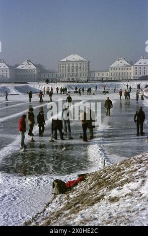 Curling on the frozen channel with Nymphenburg Castle in the background. [automated translation] Stock Photo