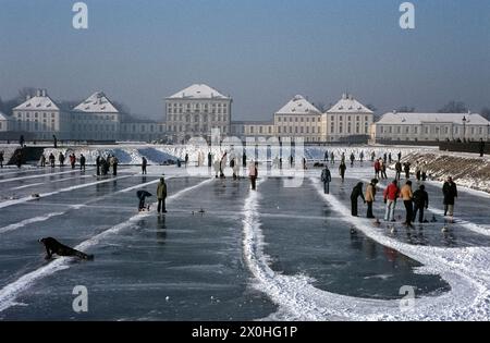 Curling on the frozen channel with Nymphenburg Castle in the background. [automated translation] Stock Photo