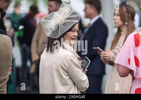 Racegoers enjoy the atmosphere during the The Randox Grand National 2024 Ladies Day at Aintree Racecourse, Liverpool, United Kingdom, 12th April 2024  (Photo by Mark Cosgrove/News Images) Stock Photo