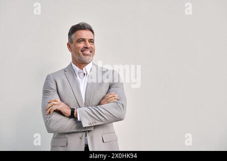 Happy middle aged business man looking away isolated on white wall. Stock Photo