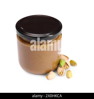 Tasty nut paste in jar and pistachios isolated on white Stock Photo