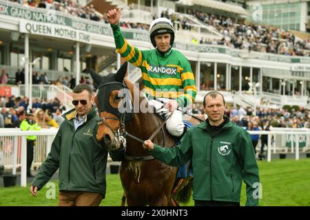 Liverpool, UK, 12th Apr, 2024. Jockey Mark Walsh salutes the crowd, alongside connections, after winning the 2.55 Trustadrader Top Novices' Hurdle at Aintree. Photo Credit: Paul Blake/Alamy Sports News Stock Photo