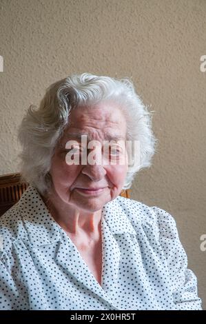 Portrait of elderly woman smiling and looking at the camera. Stock Photo