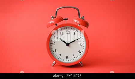 Coral old alarm clock on red background Stock Photo