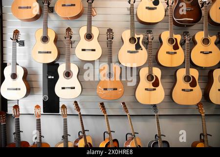 classic musical guitar instruments on display in a music shop. Stock Photo