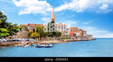 Amazing view of old Assumption of Mary church with sea and boats in foreground. Cityscape of Porec, Croatia, Europe. Traveling concept background Stock Photo