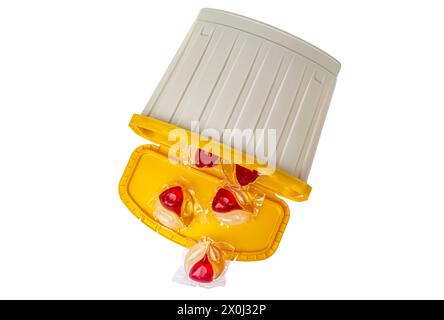 Laundry capsules and plastic containers isolated on white background. Stock Photo